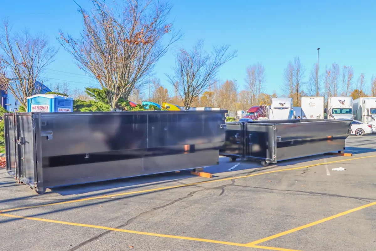 Professional dumpster rental service with roll-off container on residential driveway in Salisbury